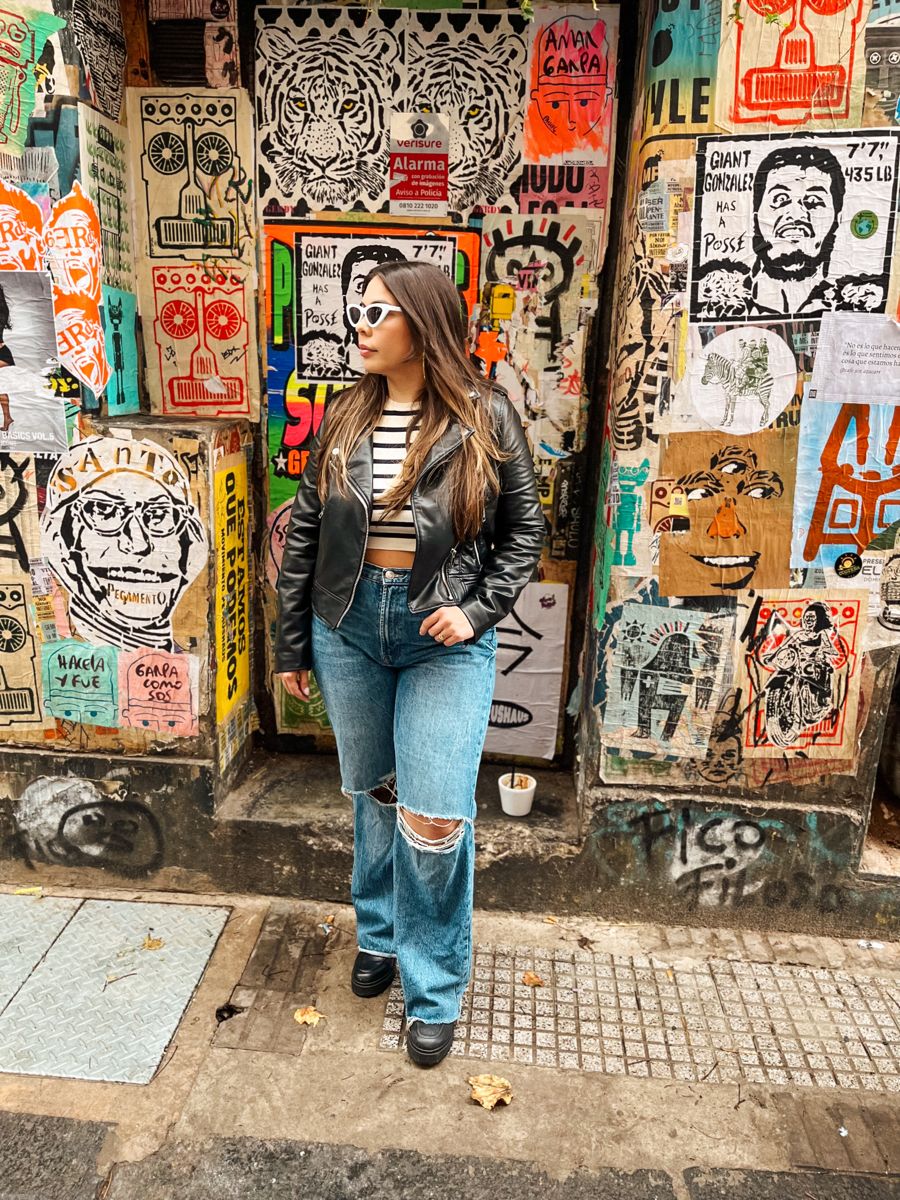 A visitor in front of a colorful street-art wall in Palermo Soho