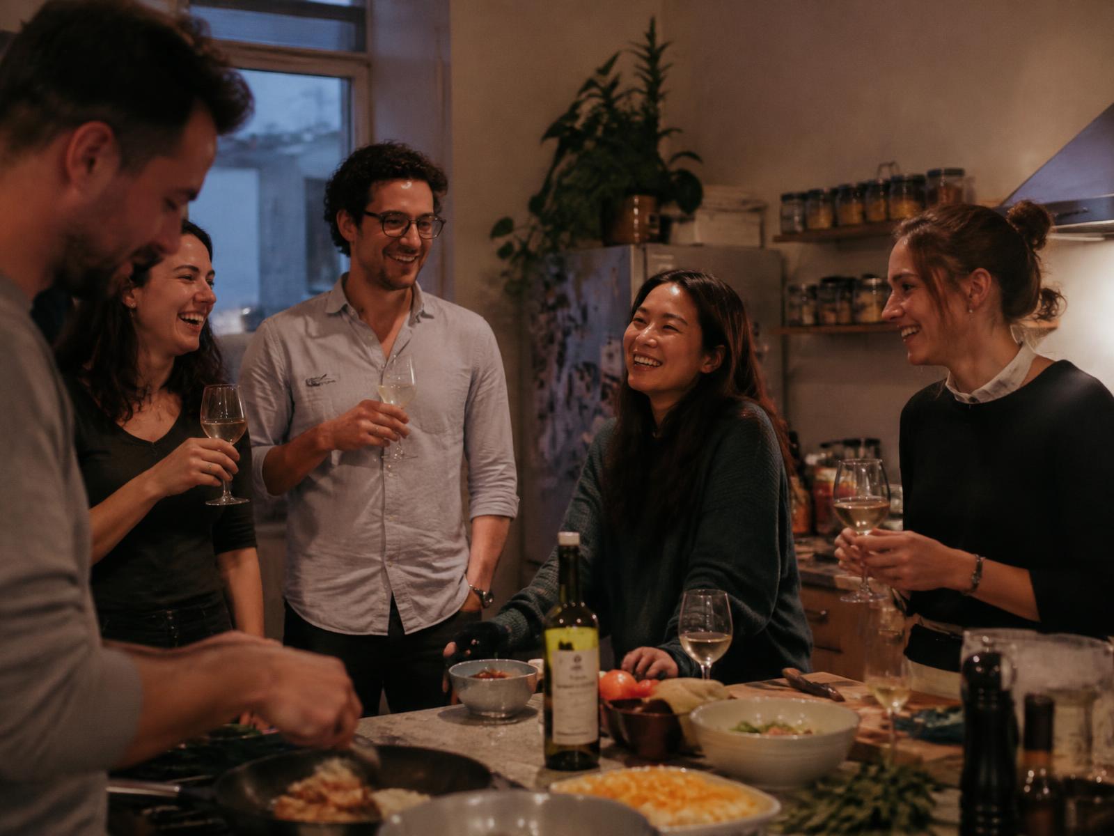 Housemates cooking and sharing dinner together